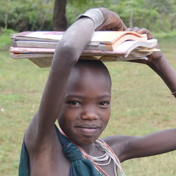 A girl carrying books on her head